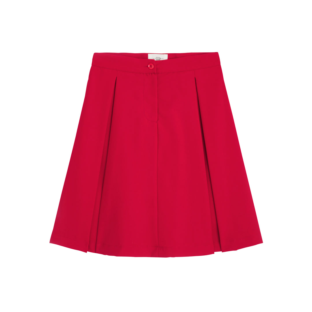 Fille en jupe trapèze d'uniforme bleu marine BERTILLE, vue de côté, avec plis élégants et taille ajustée.