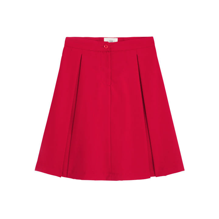 Fille en jupe trapèze d'uniforme bleu marine BERTILLE, vue de côté, avec plis élégants et taille ajustée.