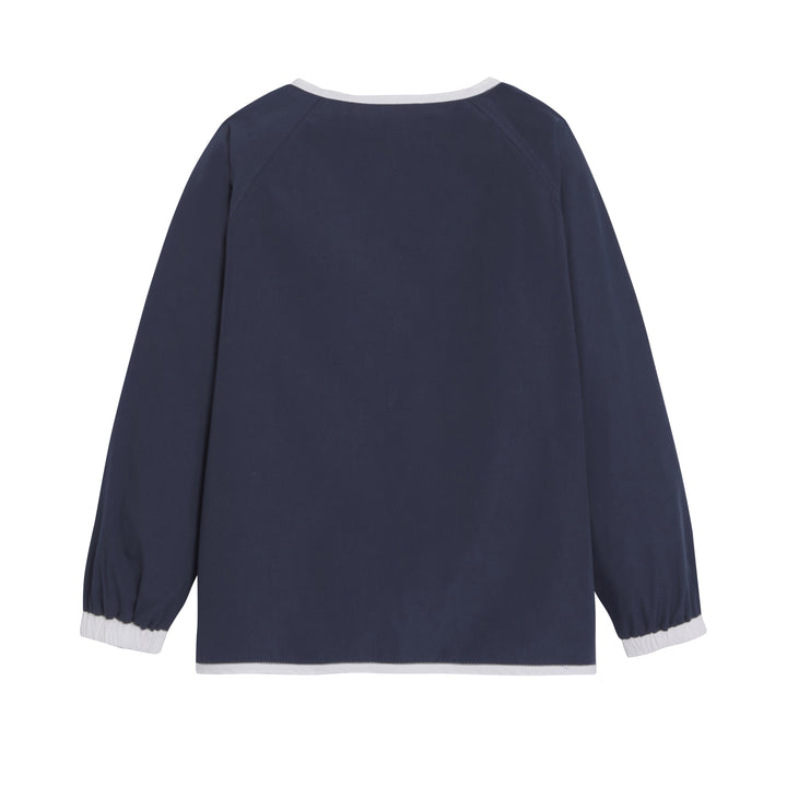 Mixte school apron in marine color by JOSEPH, featuring adjustable straps and a classic design suitable for children.